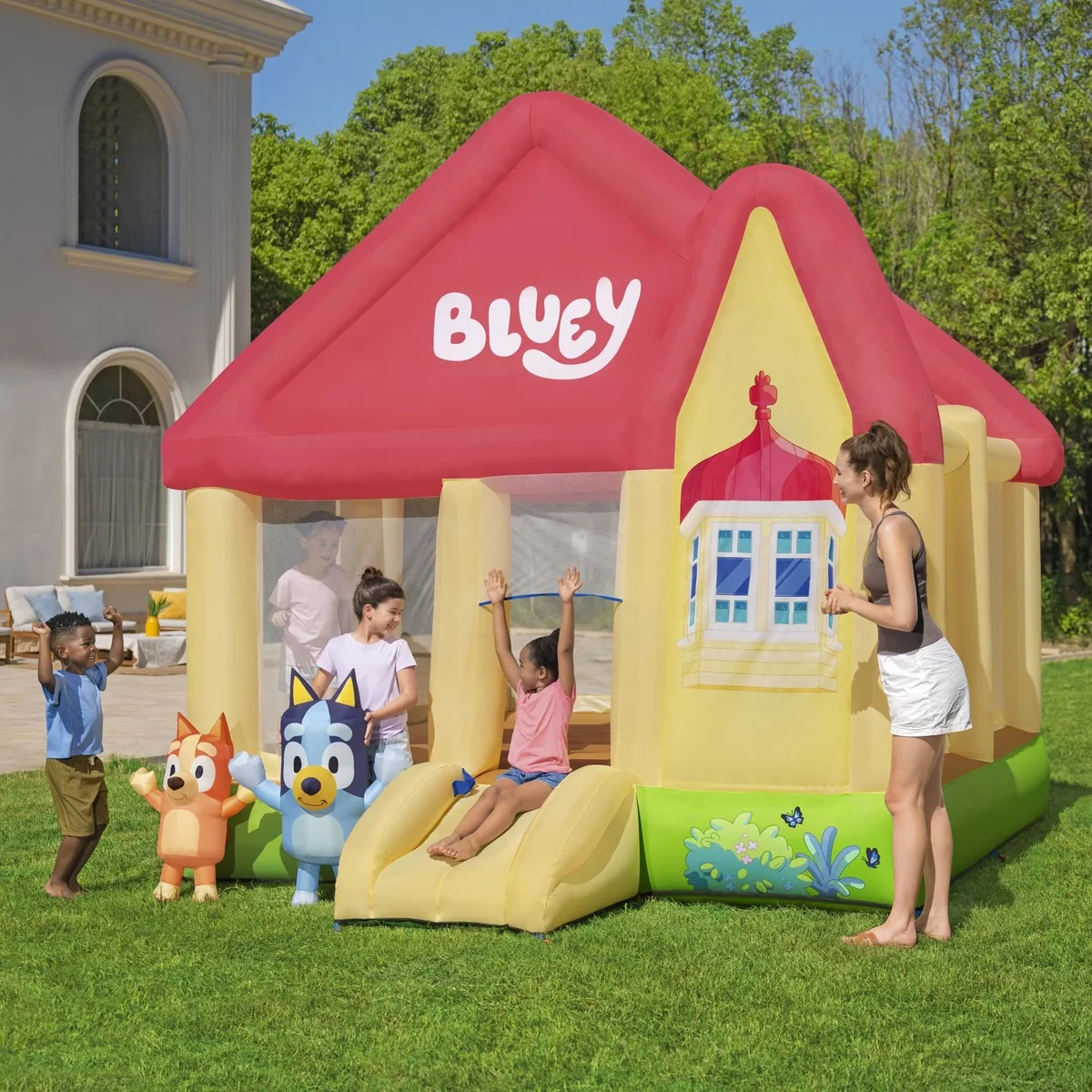 Colorful cartoon dog themed bounce house with slide