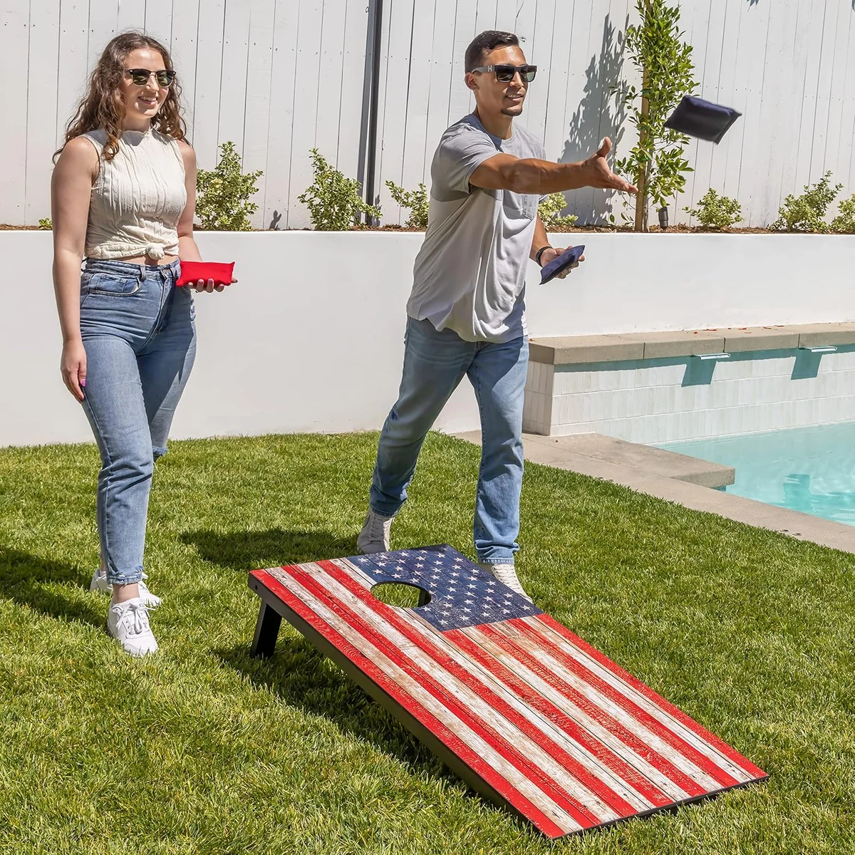 American flag cornhole board being used outdoors