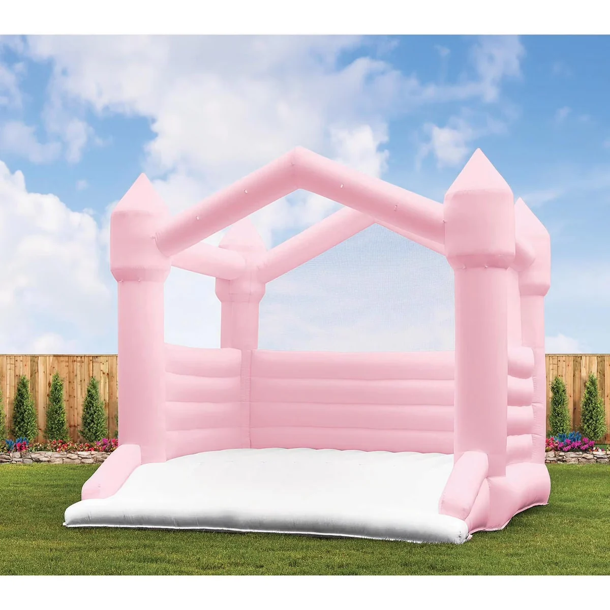 Pink castle bounce house on a lawn